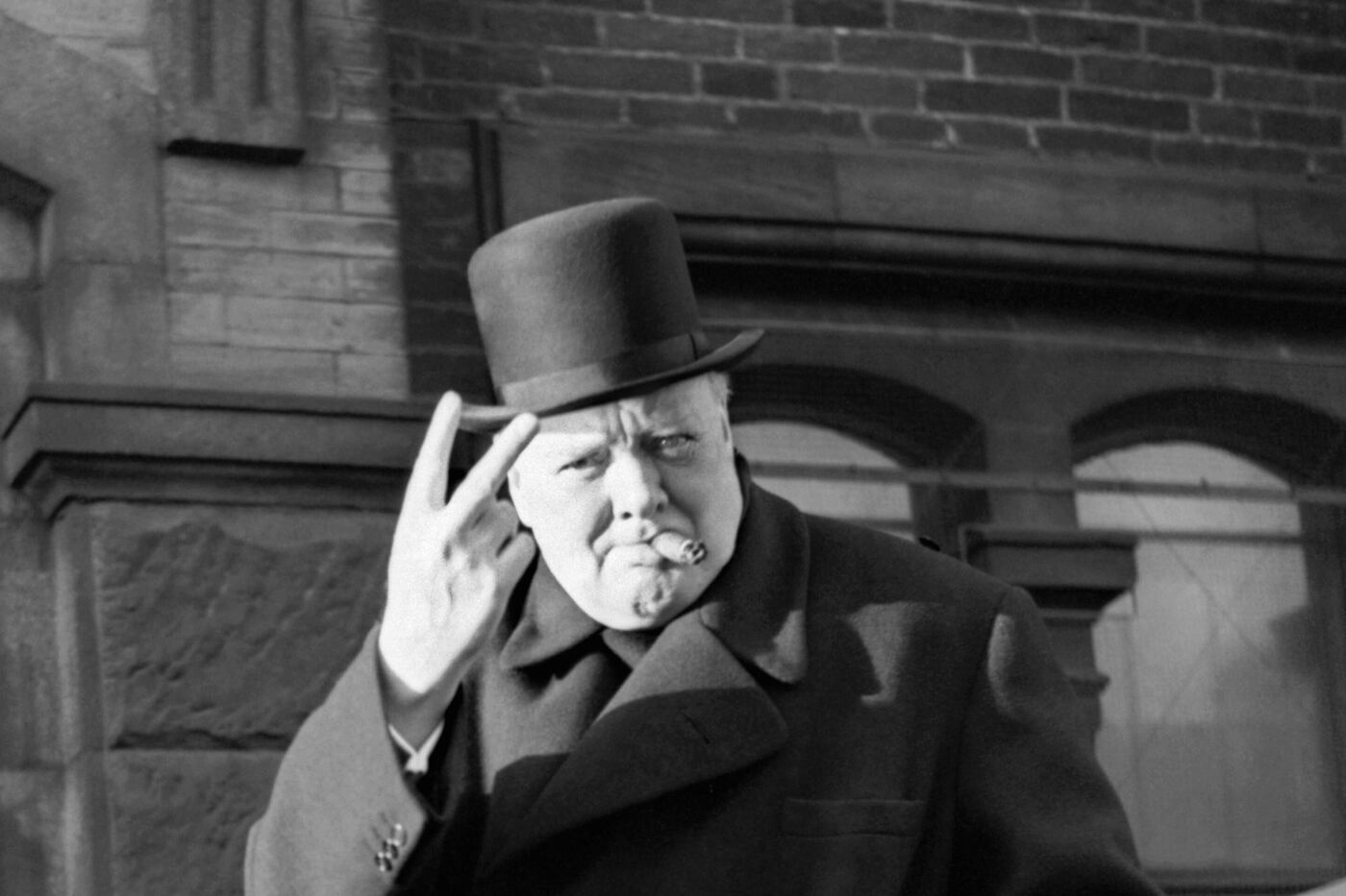 Winston Churchill, cigar in mouth, gives the V-for-victory sign — Bradford, 4 December 1942